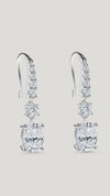 Staple pair of drop earrings for women featuring stunning oval cut stones accented with tapered round brilliant stones.