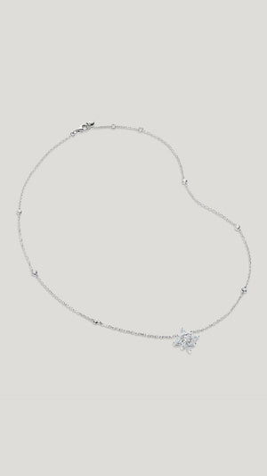  This necklace features a delicate chain embellished with Round cut stones in bezel setting. A cluster of Round and Marquise cut stones resembles a flower with a hint of vintage romance. 