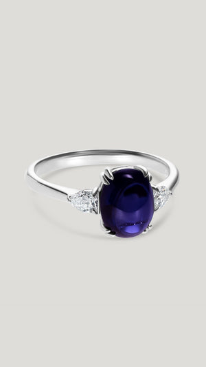 Cabochon cut Tanzanite ring for women with pear cut lab-grown diamonds either side.