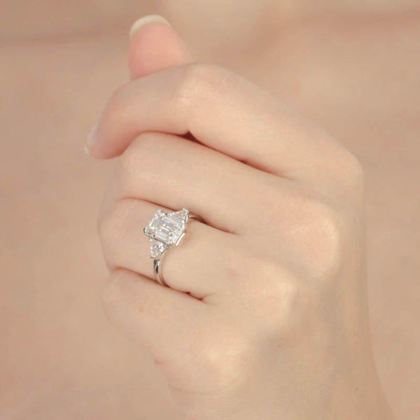 9K White Gold Trilogy Ring - 3ct Emerald Centre Stone, 2 Trillion Side Stones